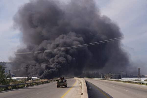 Hundreds of civilians informed murdered in massacres as violence in the spirals of Syria Photo: The smoke rises while the members of the Syrian forces travel in a vehicle in Latakia